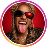 Female artist with sunglasses in a circular avatar with gradient border